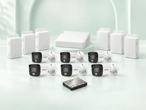 6 Hikvision DS-2CE16D0T-EXLPF cameras, DS-7108HGHI-M1/T DVR, 500GB HDD and 6 power supplies on a light mint studio background