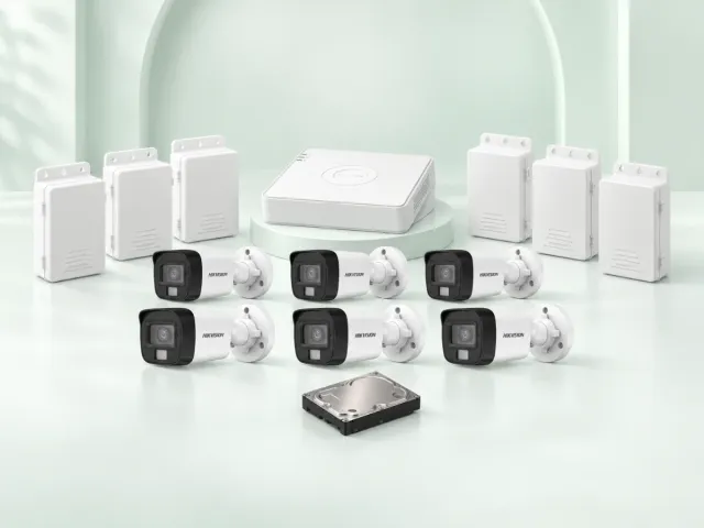 6 Hikvision DS-2CE16D0T-EXLPF cameras, DS-7108HGHI-M1/T DVR, 500GB HDD and 6 power supplies on a light mint studio background