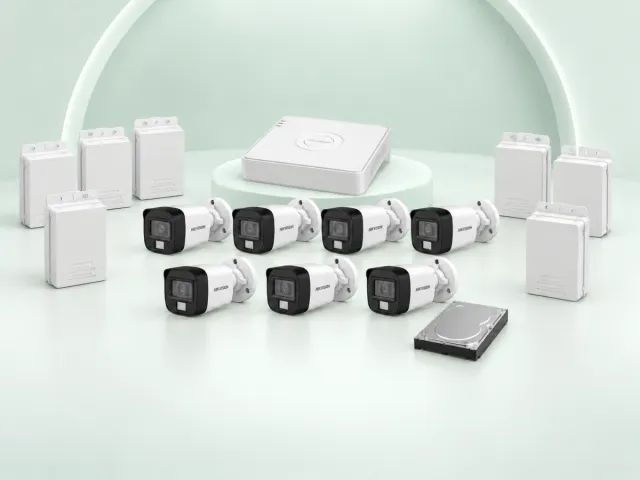 7 Hikvision DS-2CE16D0T-EXLPF cameras, DS-7108HGHI-M1/T DVR, 500GB HDD and 7 power supplies on a light mint studio background